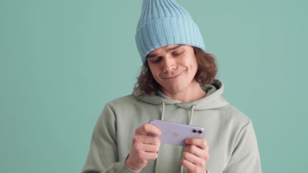 Displeased Man Blue Hat Playing Game Phone Blue Studio — Stockvideo