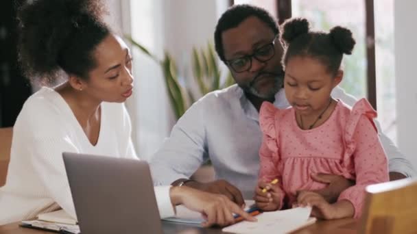 Glückliche Afrikanische Eltern Reden Und Zeigen Ihrer Tochter Hause Etwas — Stockvideo