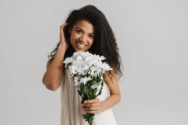 Schwarze Junge Frau Lächelt Während Sie Mit Chrysanthemen Vor Weißem — Stockfoto