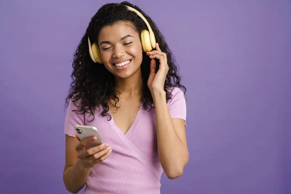 Young Black Woman Listening Music Headphones Cellphone Isolated Purple Background — Stock Photo, Image