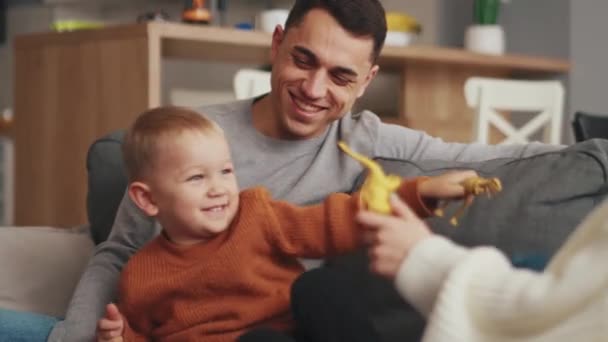 Lächelnde Familie Spielt Hause Auf Dem Sofa — Stockvideo