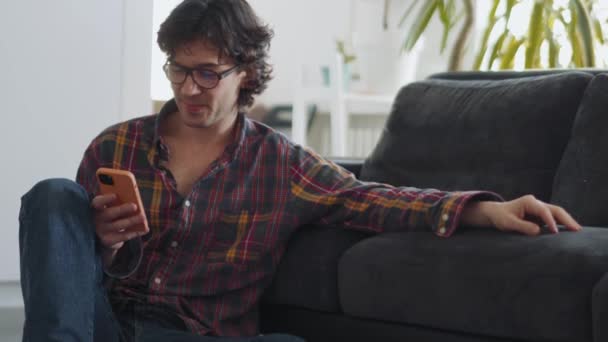 Pretty Adult Man Plaid Shirt Texting Phone Home — Stock Video