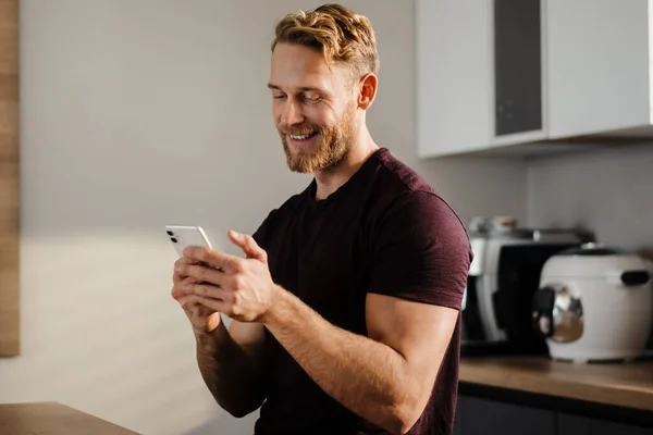 Handsome Young Man Using Mobile Phone Kitchen — Stock Photo, Image