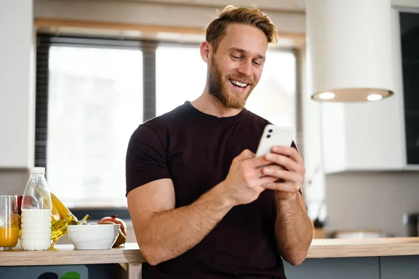 Handsome Young Man Using Mobile Phone Kitchen — Stock Photo, Image