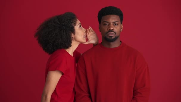 Cheerful African Woman Talking Secret Her Boyfriend Red Studio — Stock Video