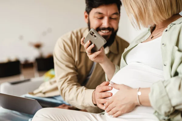 Hombre Blanco Tocando Vientre Esposa Embarazada Mientras Está Sentado Sofá — Foto de Stock