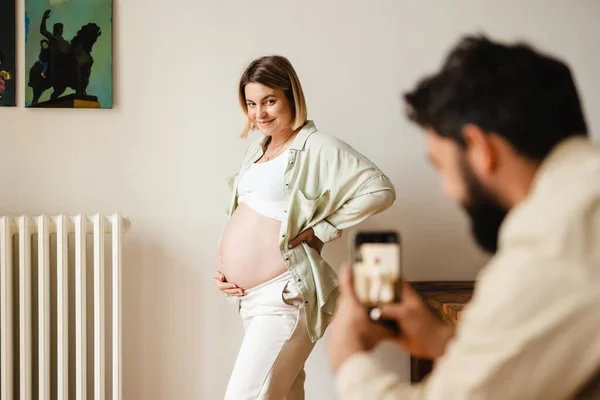 Vit Man Tar Kort Sin Leende Gravida Fru Hemma — Stockfoto