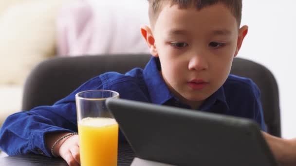 Pensive Asian Little Boy Watching Something Tablet Home — Stock Video