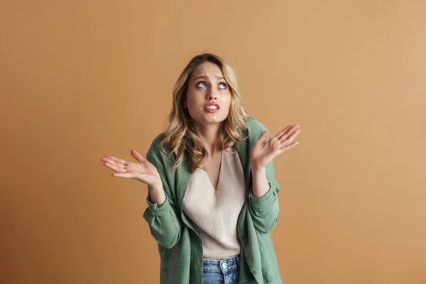 Confused Beautiful Woman Looking Upward Holding Copyspace Isolated Beige Wall — Stock Photo, Image