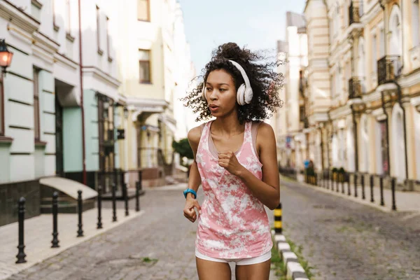 Young Black Woman Listening Music Headphones While Running City Street — Stock Photo, Image