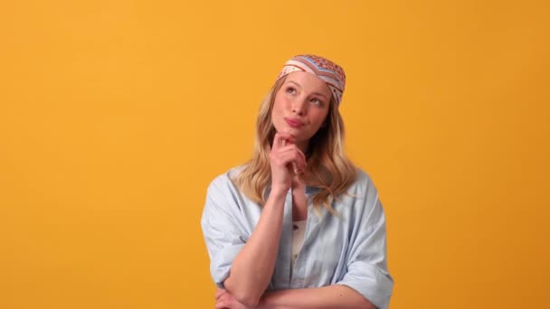 Glimlachende Blonde Vrouw Hippie Met Een Idee Camera Oranje Studio — Stockvideo