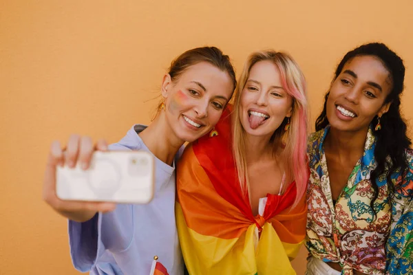 Young Multiethnic Lesbian Girls Smiling Taking Selfie Photo Yellow Wall —  Fotos de Stock
