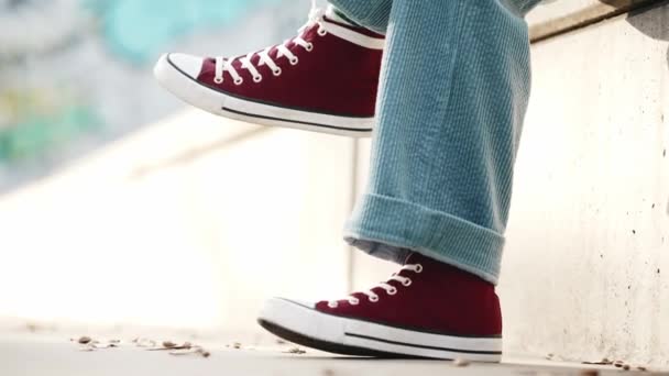 Human Legs Swaying Red Sneakers Sitting Stairs Outdoors — Stock Video