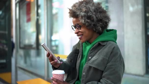 Positive Erwachsene Afrikanerin Freizeitkleidung Tippt Busbahnhof Telefon — Stockvideo