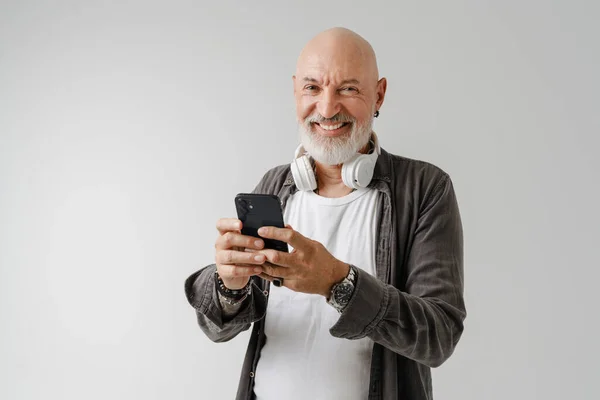 Bald European Man Headphones Using Mobile Phone Isolated White Background — Stockfoto