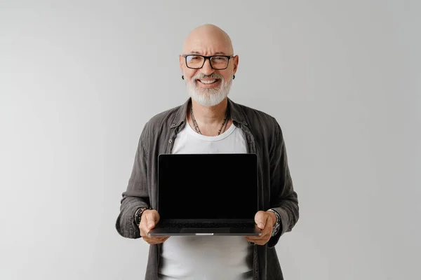 Bald European Man Eyeglasses Smiling While Showing His Laptop Isolated — Stockfoto