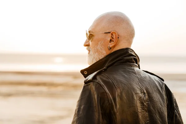 Bold Senior Man Leather Jacket Looking Aside Outdoors Summer Day — Foto Stock