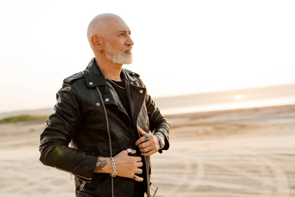 Bold Senior Man Leather Jacket Looking Aside Outdoors Summer Day — Foto Stock