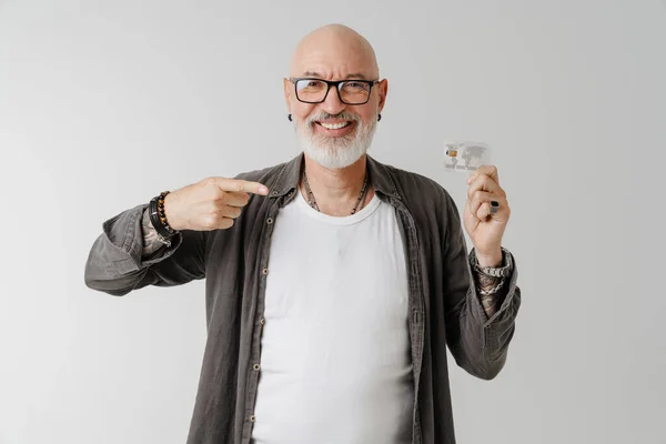 Bald European Man Eyeglasses Pointing Finger His Credit Card Isolated — стоковое фото