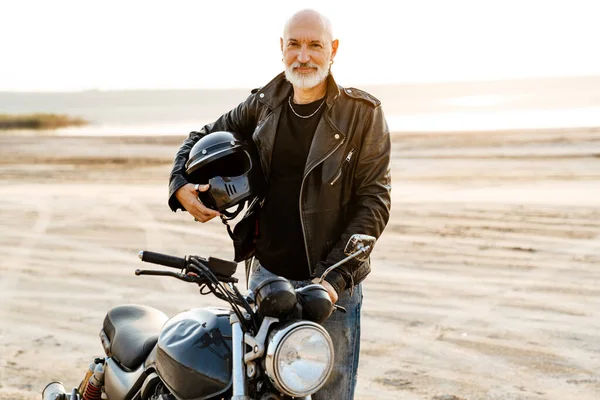 Mature Bold Man Holding Helmet While Posing Motorbike Outdoors — Foto Stock