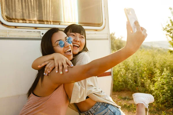 Multiracial Two Women Hugging While Taking Selfie Cellphone Trailer Outdoors — Stock Photo, Image