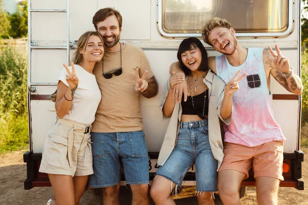 Multiracial Two Couples Gesturing Laughing Together While Leaning Trailer Outdoors — Foto Stock