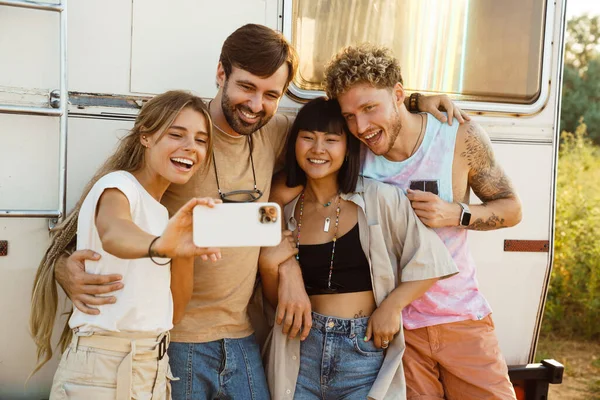 Multiracial Two Couples Laughing Taking Selfie Photo While Leaning Trailer — Foto Stock