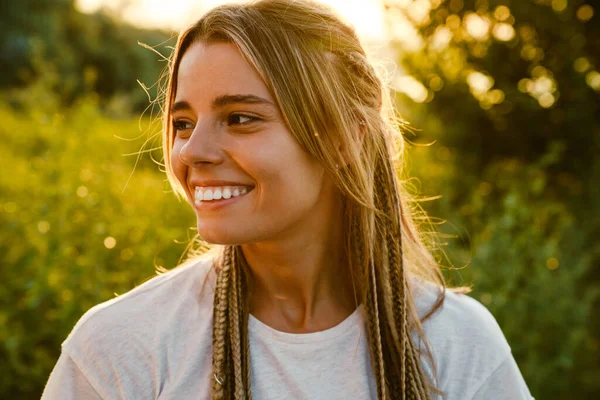 White Young Woman Pigtails Smiling Looking Aside Outdoors — стоковое фото