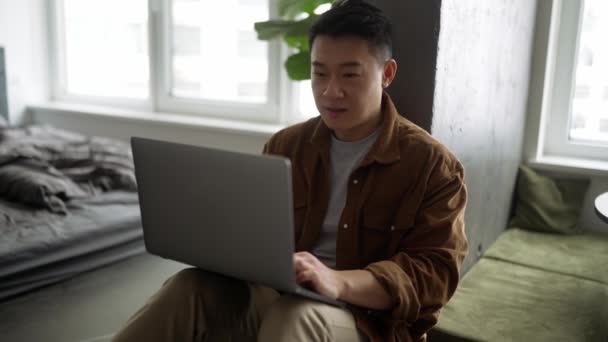 Smiling Asian Man Wearing Casual Cloth Working Laptop Home — Stock Video