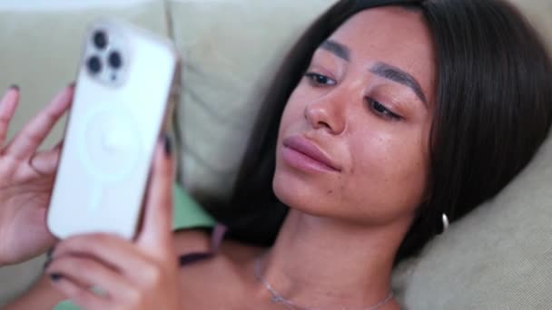 Positive African Woman Wearing Pajama Looking Phone Sofa Home — стокове відео