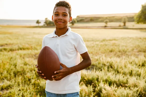 Black Boy Wearing White Shirt Smiling While Posing Rugby Ball — Stockfoto