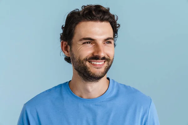 Young Brunette Man Bristle Smiling Looking Aside Isolated Blue Background — Zdjęcie stockowe