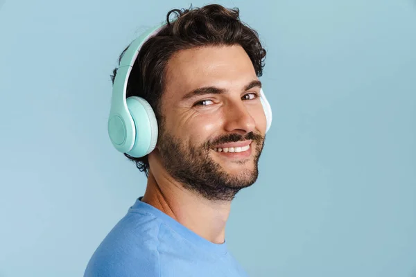 Young Brunette Man Bristle Listening Music Headphones Isolated Blue Background — Stock Photo, Image