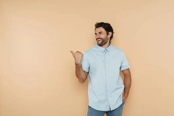 Young White Man Wearing Shirt Laughing Pointing Finger Aside Isolated — стоковое фото