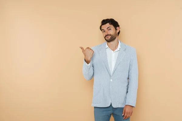 Young White Man Looking Camera Pointing Finger Aside Isolated Beige —  Fotos de Stock