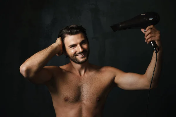 Young Half Naked Man Smiling While Using Hair Dryer Isolated — Foto de Stock