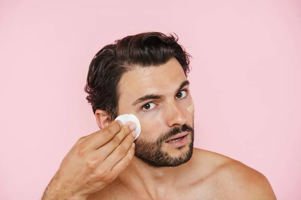 White Shirtless Man Applying Concealer Cotton Pad Isolated Pink Background — Stockfoto