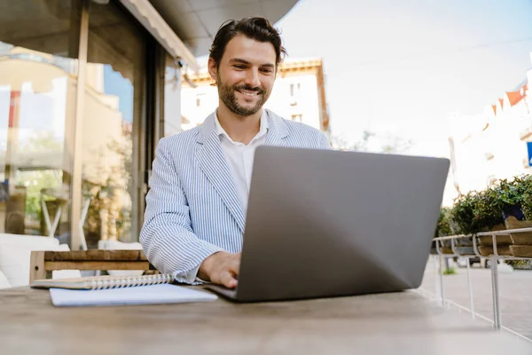 Young Man Wearing Jacket Working Laptop While Sitting Cafe Outdoors — Stockfoto