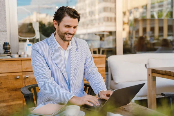 Young Man Wearing Jacket Working Laptop While Sitting Cafe Outdoors — Stockfoto