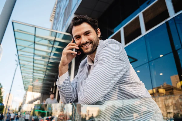 Young Man Wearing Jacket Smiling While Talking Mobile Phone Outdoors — Photo