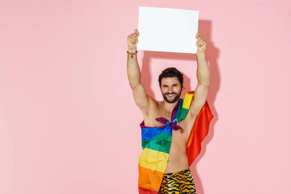 Hombre Joven Sin Camisa Con Bandera Arco Iris Sonriendo Mientras —  Fotos de Stock