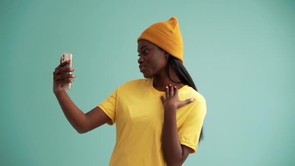 Pretty African Woman Making Selfie Photo Phone Turquoise Studio — Stock videók