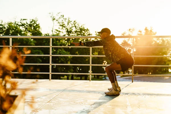 Young Sportsman Doing Exercise While Working Out Railings Outdoors — Stock Fotó