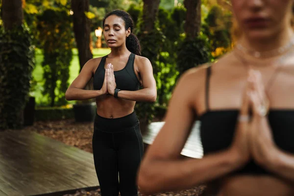 Multiracial Dos Mujeres Meditando Durante Práctica Yoga Aire Libre —  Fotos de Stock