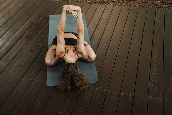 White Young Woman Doing Exercise Yoga Practice Outdoors — стоковое фото