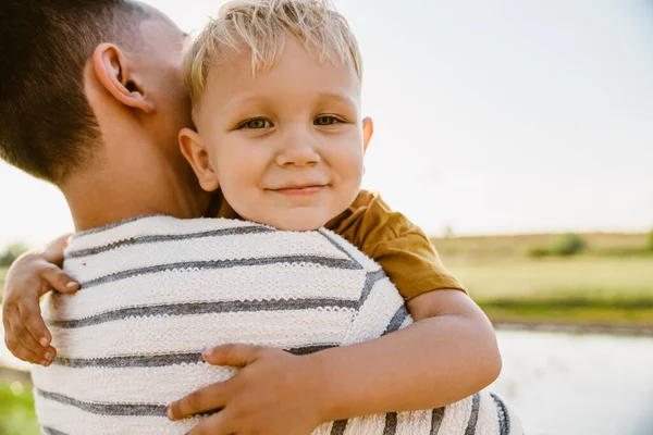 Young White Father Wearing Striped Shirt Holding His Son Outdoors — Stock Photo, Image
