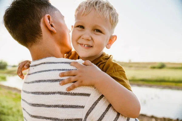 Young White Father Wearing Striped Shirt Holding His Smiling Son — Stock Photo, Image