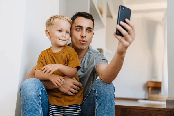 Young Father Son Smiling Taking Selfie Photo Mobile Phone Home — Fotografia de Stock