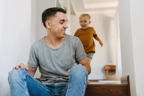 Young White Father Playing His Son While Sitting Stairs Home — Fotografia de Stock