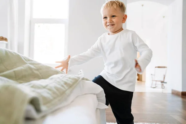 White Blonde Boy Wearing Home Clothes Laughing Playing Indoors — стоковое фото